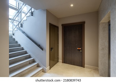 Modern interior of entrance hall in luxury residential apartment complex. Staircase. Dorrs to apartment. - Shutterstock ID 2180839743