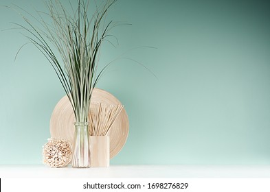 Modern Interior In Farmhouse Style - Bamboo Plate, Sheaf Of Cane In Glass Bottle, Decorative Round Sheaf Of Twigs, Sticks On Green Mint Menthe Wall, White Wood Table.