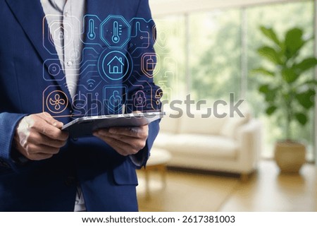 A modern interior featuring a man using a tablet to control a smart home interface. The image showcases technology integration, emphasizing user-friendly design and automation.