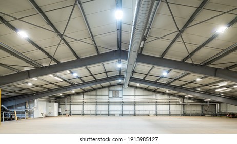 Modern Interior Of Huge Empty Warehouse. New Distribution Storehouse. Metal Construction. Industrial Architecture.