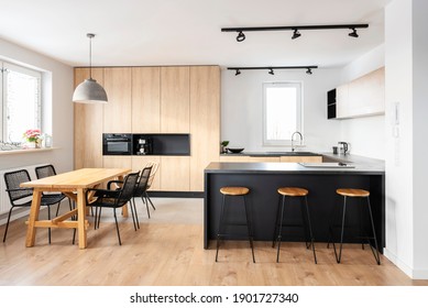 Modern interior of kitchen with kitchen island, granite kitchen island, wooden furnitureand stylish table and chairs. Spacious and luxurious space in apartment.  - Shutterstock ID 1901727340