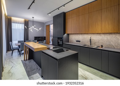 Modern interior of kitchen in luxury private house. Grey and wooden design. Marble floor. Panorama windows. Stylish kitchen set. - Shutterstock ID 1932352316
