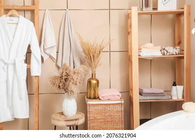 Modern interior of light bathroom with towels and bathrobe - Powered by Shutterstock