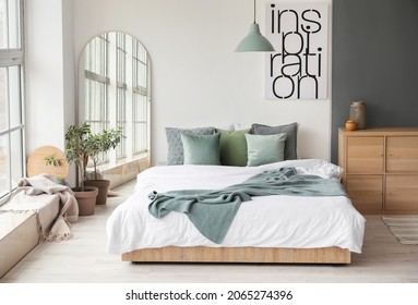 Modern interior of light bedroom with mirror