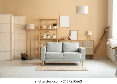 Modern interior of living room with cozy grey sofa and carpet