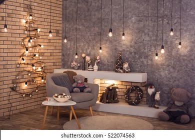 Modern Interior Of Living Room. Creative Christmas Tree, Contemporary Fireplace And Large Gray Armchair In Loft Interior Design Apartment.