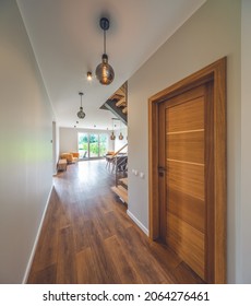 Modern Interior Of Luxury Apartment. Private House. No People. Wooden Door In Hallway To Living Room.