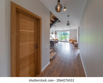 Modern Interior Of Luxury Apartment. Private House. No People. Wooden Door In Hallway To Living Room.