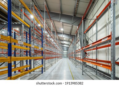 Modern interior of new empty warehouse. Racks pallets shelves. Metal construction. Storage equipment. Distribution storehouse.