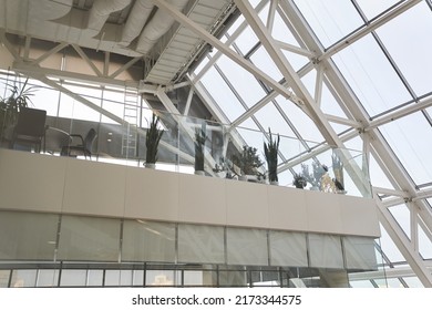 Modern Interior Of An Office Building.The Interior Of A Modern Multi-storey Business Center With Large Windows And Many Offices In Front Of Them. Green Plants In Pots. High Quality Photo