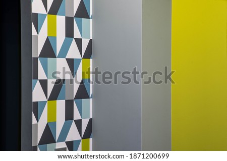 Modern interior of room in contemporary apartment. Mosaic wallpaper. Grey and yellow wall.