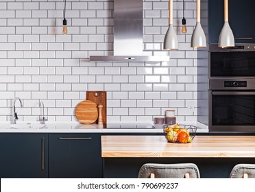 Modern interior. Spacious  kitchen  with white brick tile wall.