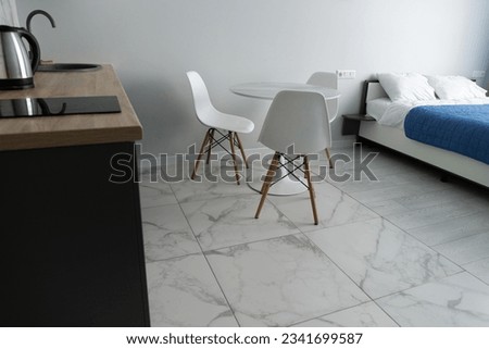 Modern interior of tiny studio appartment. Modern bedroom and kitchen in tiny home