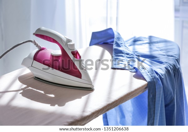 Modern iron and clothes on\
board