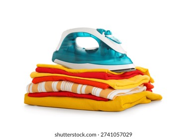 Modern iron with stack of clean clothes isolated on white background