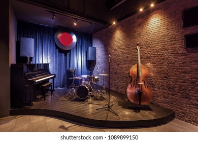 Modern jazz bar interior design, stage with black piano and cello