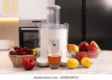 Modern juicer, fresh fruits and glass on white marble table in kitchen - Powered by Shutterstock