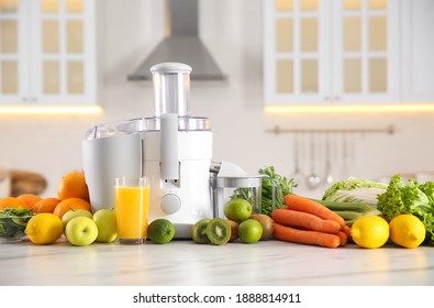 Modern juicer, fresh vegetables and fruits on table in kitchen - Powered by Shutterstock