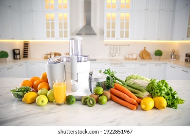 Modern juicer, fresh vegetables and fruits on table in kitchen - Powered by Shutterstock