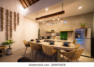 modern kitchen with appliances. Subtle lighting. dining table made of polished concrete. - Shutterstock ID 2049476078