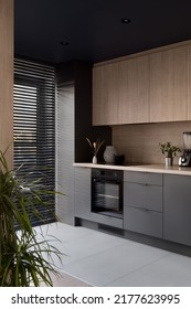 Modern Kitchen With Black Ceiling, Wooden Furniture And Big Window With Black Blinds