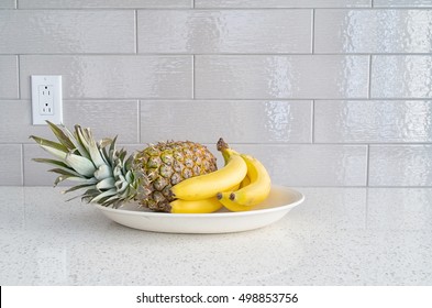 Modern Kitchen Countertop With Fruits Dish Against Gray Backsplash