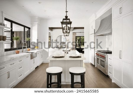 A modern kitchen featuring white cabinets and marble countertops, accented with a sleek black stool for a contemporary look