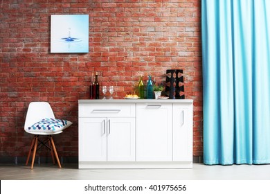 Modern kitchen furniture against brick wall background