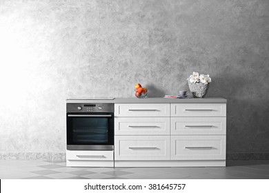 Modern Kitchen Furniture Against Grey Wall