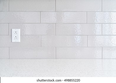 Modern kitchen granite countertop  against gray ceramic backsplash