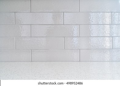 Modern kitchen granite countertop  against gray ceramic backsplash
