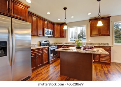 Modern Kitchen With Hardwood Floor And Granite Counter Tops.