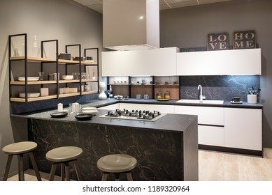 Modern Kitchen Interior With Centre Island With Bar Stools And Hob, White Cabinets And Open Shelving