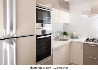 Modern Kitchen Interior With Combination Oven, Microwave And Fridge