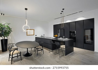MODERN KITCHEN INTERIOR WITH DINING TABLE AND WOODEN FLOOR