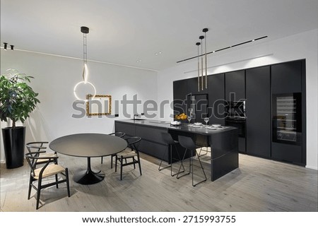 MODERN KITCHEN INTERIOR WITH DINING TABLE AND WOODEN FLOOR