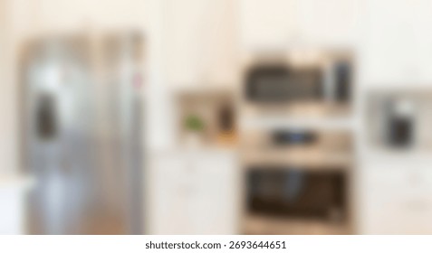 Modern kitchen interior features stainless steel appliances and white cabinetry creating a bright background.