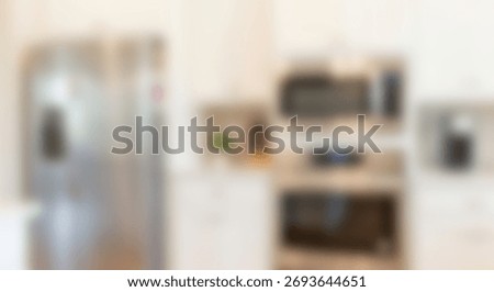 Modern kitchen interior features stainless steel appliances and white cabinetry creating a bright background.