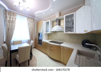 Modern kitchen interior with golden cabinets in the apartment