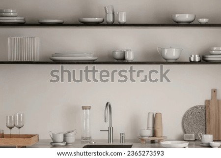 Modern kitchen interior in minimal style with sink and faucet and shelving unit with white ceramic furniture