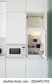 Modern kitchen interior. Opened fridge at the kitchen