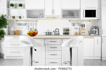 Modern kitchen interior with wooden table and microwave oven - Shutterstock ID 793002772