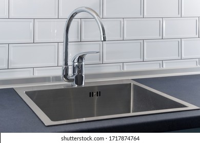 Modern Kitchen Metal Faucet And Stainless Steel Sink.
