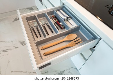Modern kitchen, Open drawers, Set of cutlery trays in kitchen drawer. Plastic equipment for drawer inserts.   