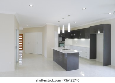 Modern Kitchen With Overhead Lights And Island Work Bench