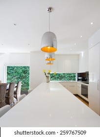 Modern Kitchen Renovation With Hanging Chrome Pendant Light