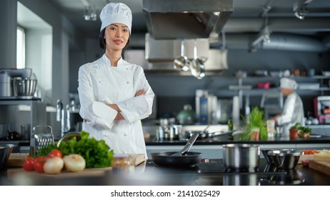 Modern Kitchen Restaurant: Portrait of Asian Female Chef, Crossing Arms and Looking at Camera Smiles. Professional Cooking Delicious and Authentic Food, Cuts Vegetables, Preparing Healthy Meal - Shutterstock ID 2141025429