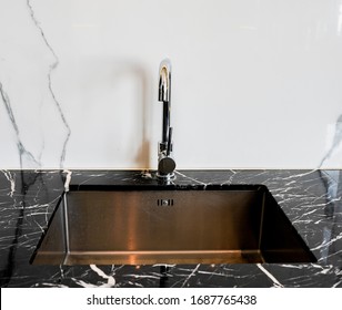 Modern kitchen sink with marble counter interior background.