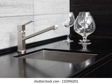 Modern Kitchen Sink With Metal Tap And Black Marble