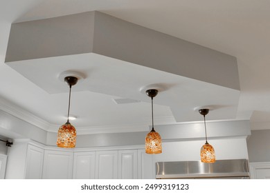 Modern Kitchen With Trio Of Pendant Lights Hanging From Stylish Ceiling Fixture - Powered by Shutterstock